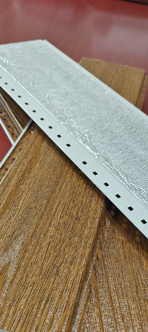 Close view of narrow V-groove metal cladding shadow lines